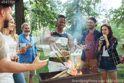 Image of Group of friends making barbecue in the backyard. concept about good and positive mood with friends