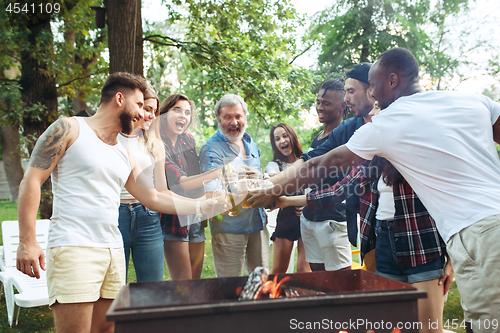 Image of Group of friends making barbecue in the backyard. concept about good and positive mood with friends