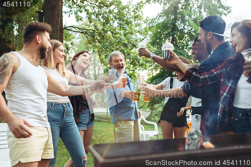 Image of Group of friends making barbecue in the backyard. concept about good and positive mood with friends