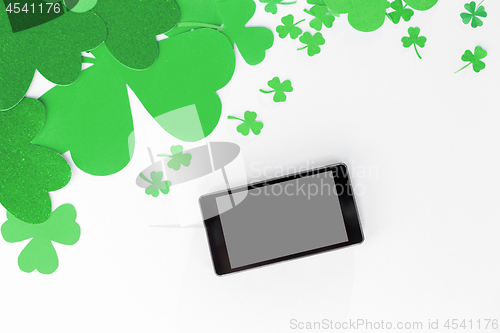 Image of tablet pc and st patricks day decorations on white