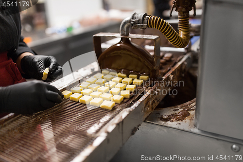 Image of confectioner with chocolate coating machine