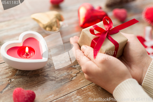 Image of close up of hands holding christmas gift