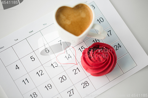 Image of close up of calendar, coffee, cupcake and heart