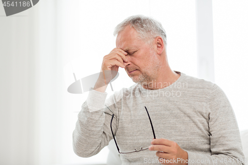 Image of senior man with having headache