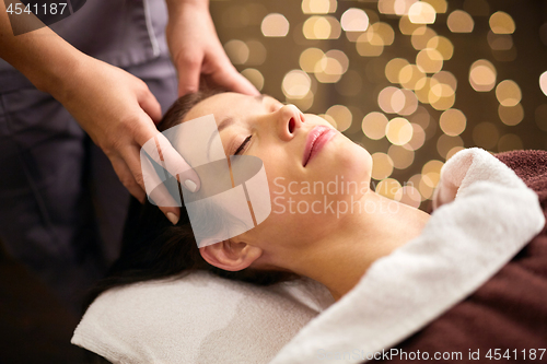 Image of woman having head massage at spa
