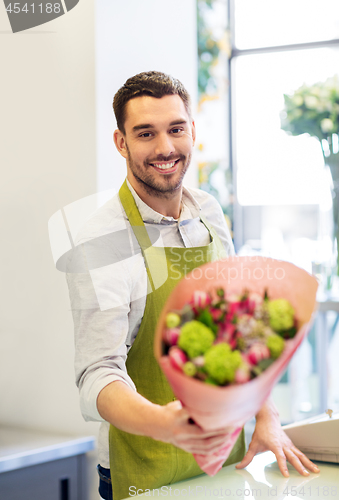 Image of smiling florist man with bunch at flower shop