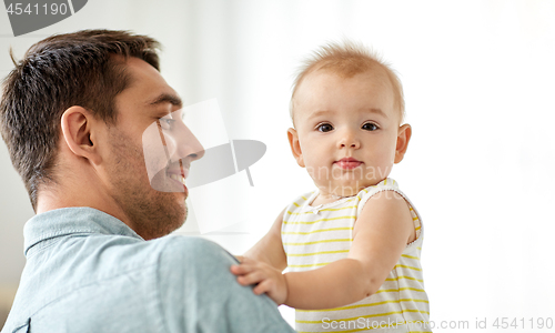 Image of father with little baby daughter at home