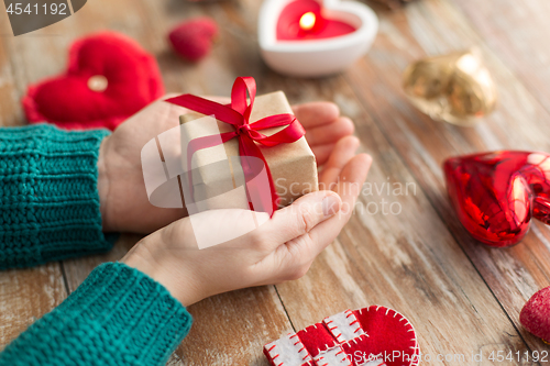 Image of close up of hands holding christmas gift