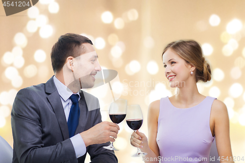 Image of young couple with glasses of wine at restaurant