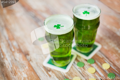 Image of glasses of green beer with shamrock and gold coins