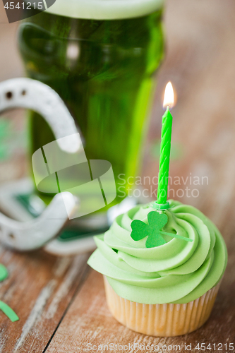 Image of green cupcake with candle, beer and horseshoe