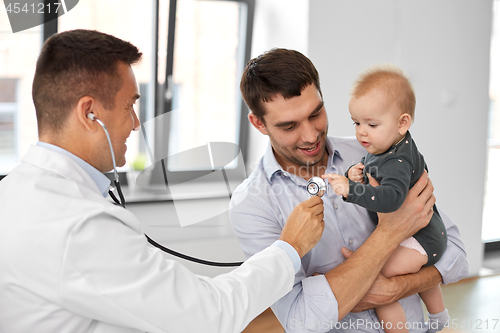 Image of father with baby and doctor at clinic