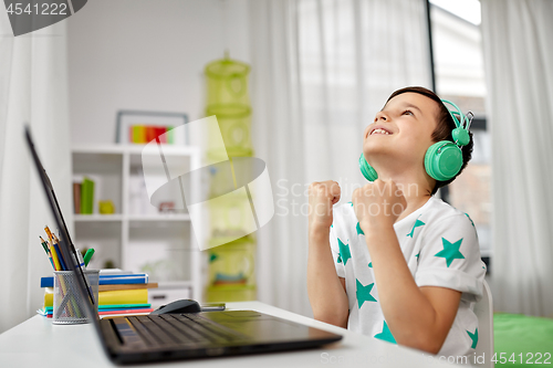 Image of boy celebrating victory in computer video game