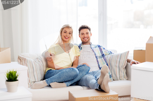 Image of happy couple with boxes moving to new home