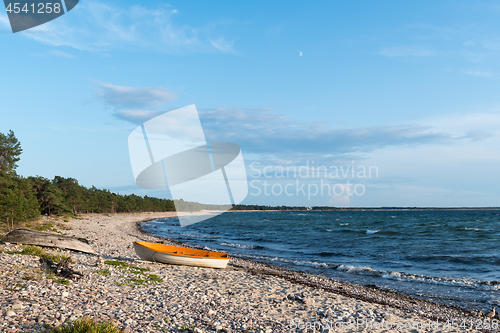 Image of Landed colorful rowing boat in a bay with blue water