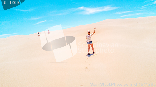 Image of Aussie woman enjoying the vast sand dunes in summer