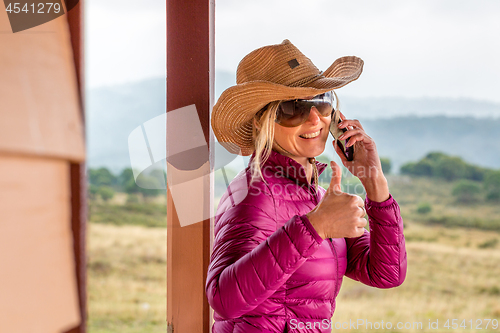 Image of RUOK Happy woman at rural ranch with thumbs up gesture