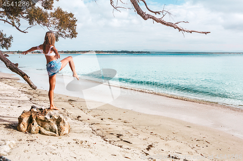 Image of Wioman exercising on beach