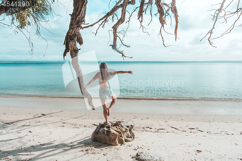 Image of Girl at idyllic beach in early morning, balance, fitness, freedo