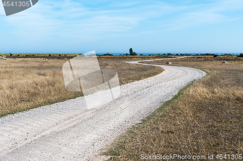 Image of Winding gravel road in a barren landscape
