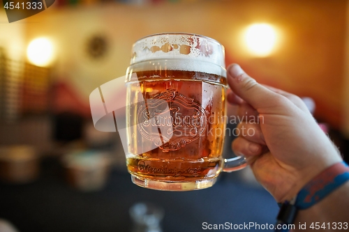 Image of Holding a glass of Czech beer