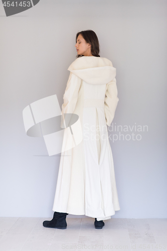 Image of woman in a white coat with hood isolated on white background