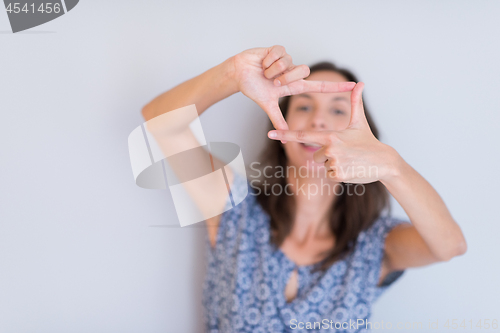 Image of woman showing framing hand gesture