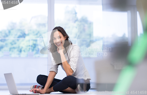 Image of young women using laptop computer on the floor