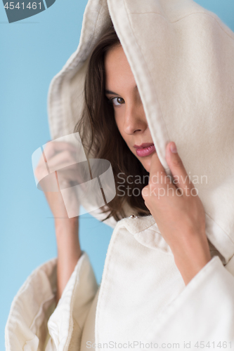 Image of woman in a white coat with hood isolated on blue background