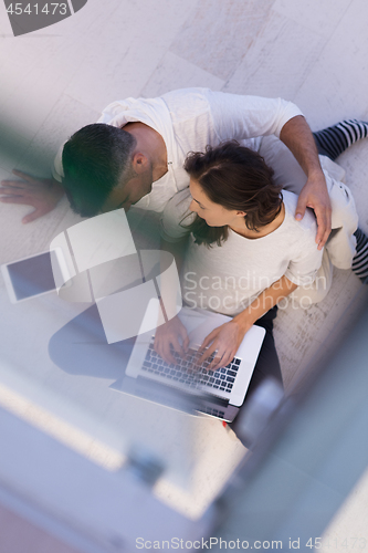 Image of couple using tablet and laptop computers top view