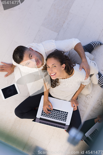 Image of couple using tablet and laptop computers top view