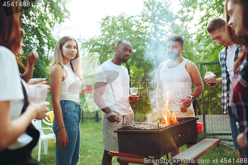 Image of Group of friends making barbecue in the backyard. concept about good and positive mood with friends