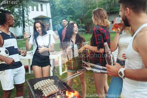 Image of Group of friends making barbecue in the backyard. concept about good and positive mood with friends