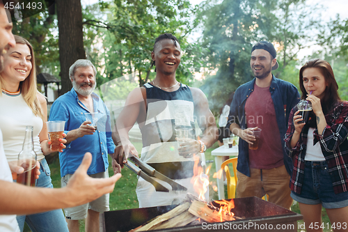 Image of Group of friends making barbecue in the backyard. concept about good and positive mood with friends