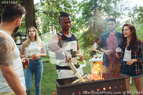 Image of Group of friends making barbecue in the backyard. concept about good and positive mood with friends