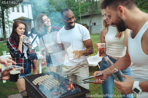 Image of Group of friends making barbecue in the backyard. concept about good and positive mood with friends