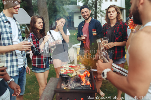 Image of Group of friends making barbecue in the backyard. concept about good and positive mood with friends