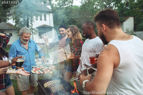 Image of Group of friends making barbecue in the backyard. concept about good and positive mood with friends