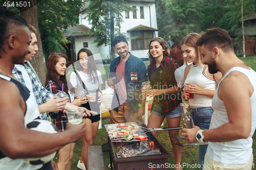 Image of Group of friends making barbecue in the backyard. concept about good and positive mood with friends