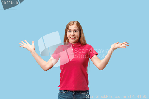 Image of The happy business woman standing and smiling against blue background.
