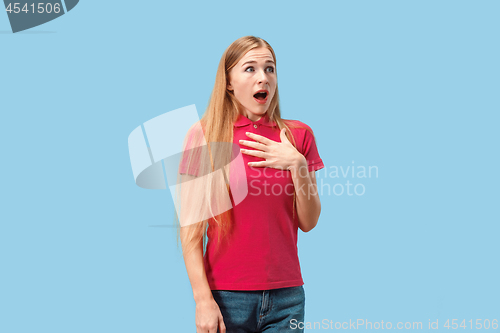 Image of Beautiful woman looking suprised isolated on blue