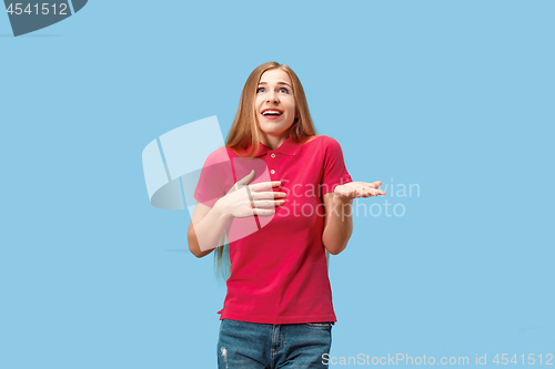 Image of Beautiful woman looking suprised isolated on blue