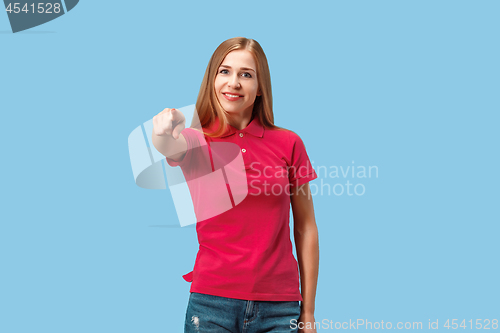 Image of The happy business woman point you and want you, half length closeup portrait on blue background.