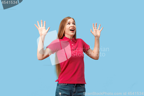 Image of Beautiful woman looking suprised isolated on blue