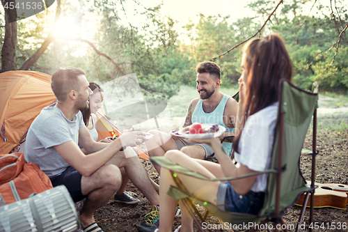 Image of Party, camping of men and women group at forest. They relaxing and eating barbecue