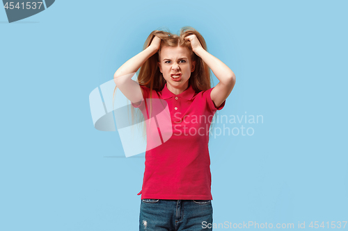 Image of The young emotional angry and scared woman standing and looking at camera