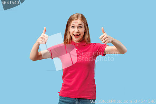 Image of The happy business woman standing and smiling against blue background.