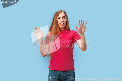 Image of Portrait of the scared woman on blue