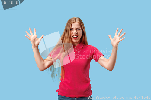 Image of The young emotional angry and scared woman standing and looking at camera