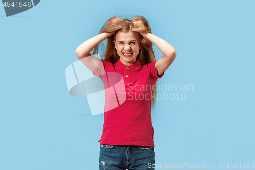 Image of The young emotional angry and scared woman standing and looking at camera